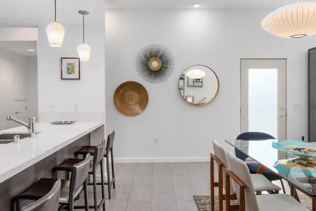 a view of a kitchen with table and chairs