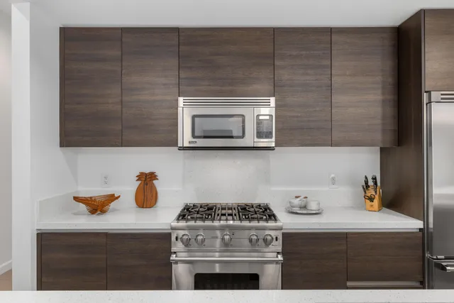 a stove top oven sitting inside of a kitchen