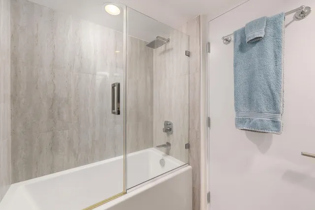 a bathroom with a tub a sink and a shower