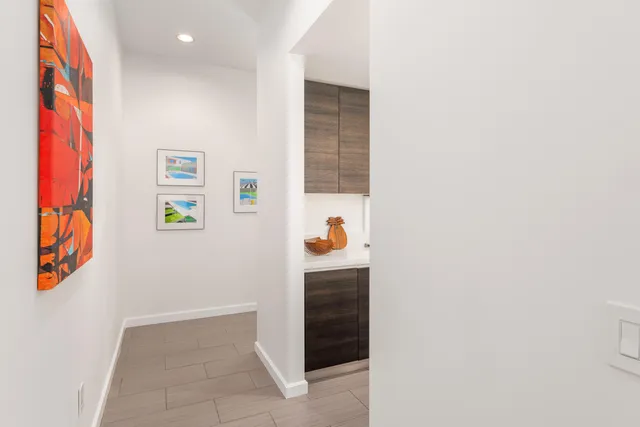 a hallway with painting on the wall