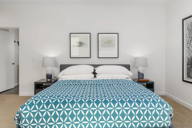 a bedroom with a bed and a lamp