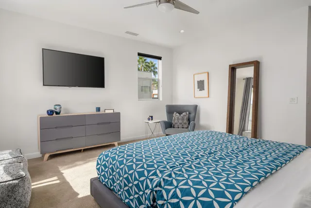 a bedroom with a bed and a flat screen tv