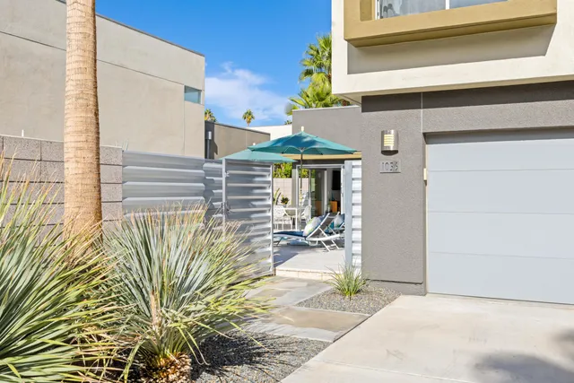 a view of a patio with table and chairs under an umbrella