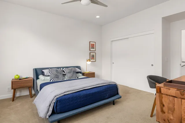 a bedroom with a bed and a chair