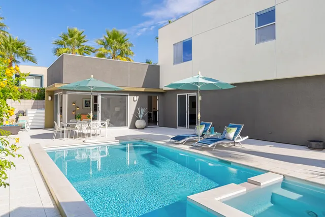 a patio with a table and chairs