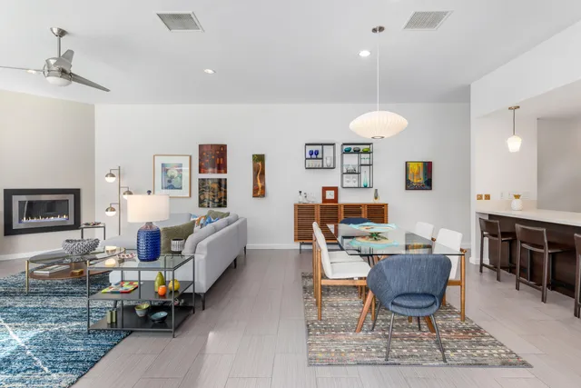 a living room with furniture and a dining table