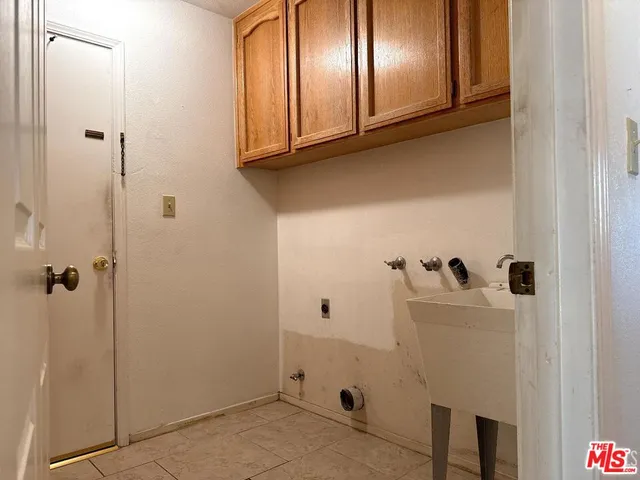a view of a refrigerator in kitchen and cabinets