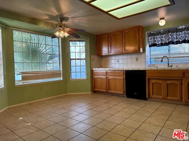 a kitchen with a sink cabinets and window