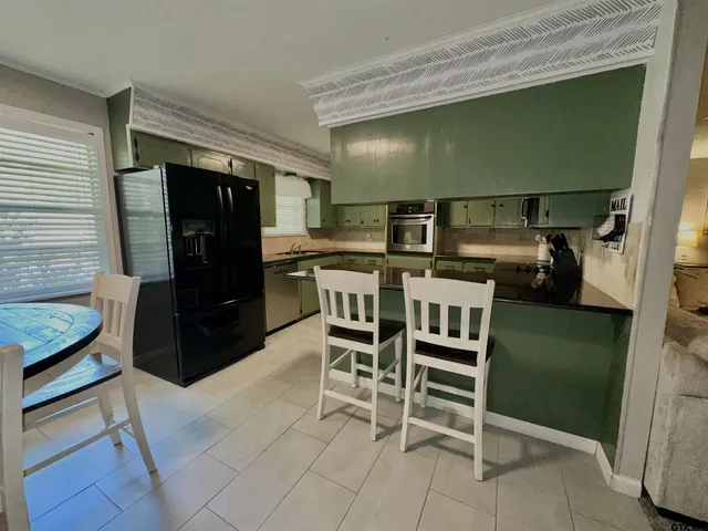 a kitchen with a table and chairs