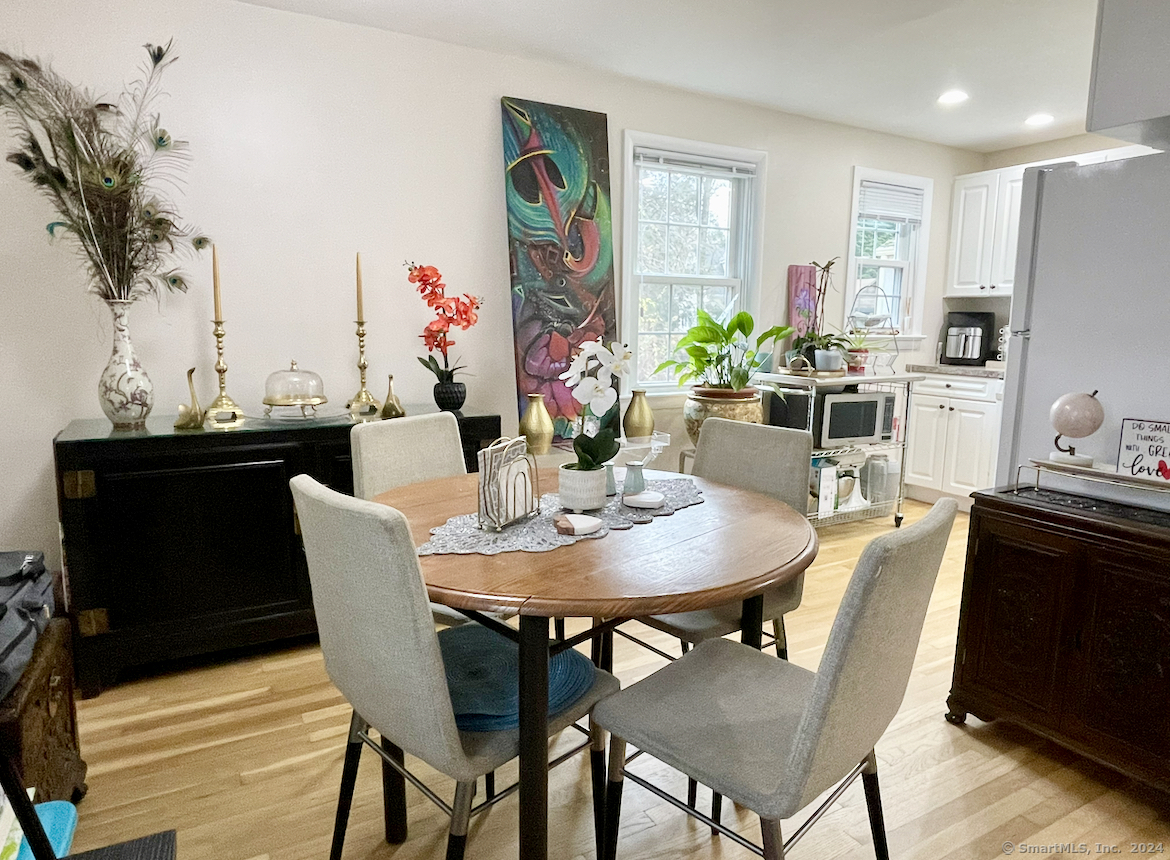 104 Perry Avenue, Unit A Norwalk, CT 06850 - Photo 1 of 1 a view of a dining room with furniture and wooden floor