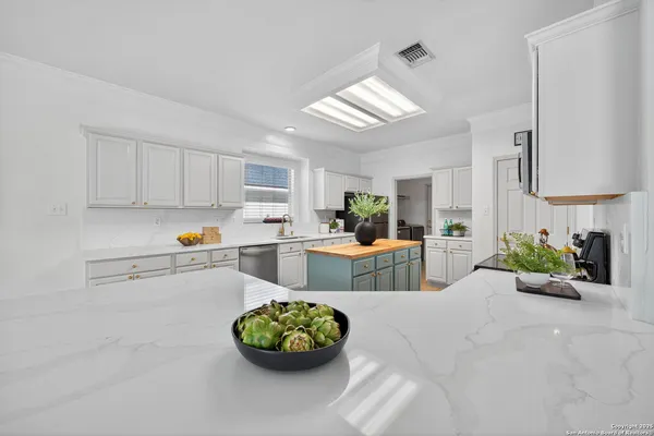 a kitchen with a white cabinets and white appliances