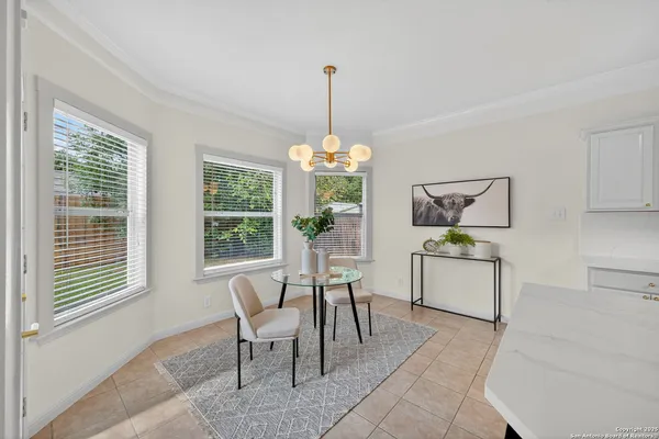 a kitchen with a table and chairs in it