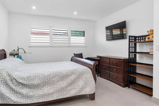a living room with furniture a flat screen tv and a potted plant
