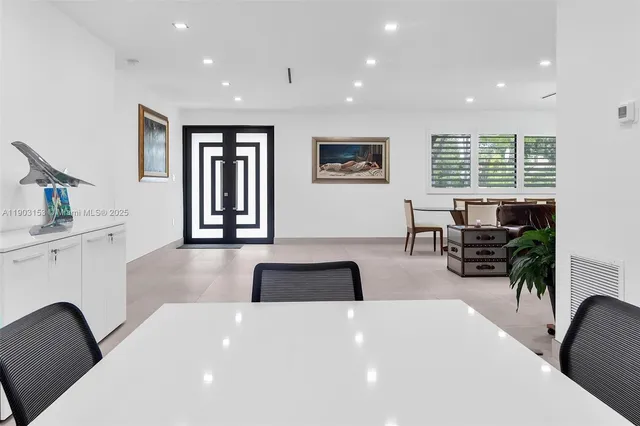 a large white kitchen with a large window