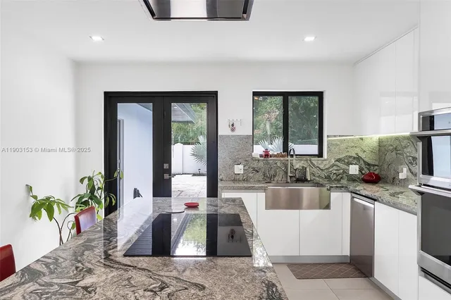 a kitchen with a sink and a large window