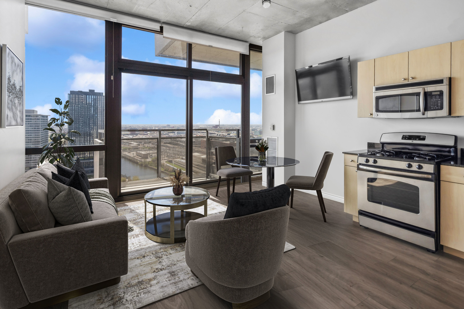 235 West Van Buren Street, Unit 2708 Chicago, IL 60607 - Photo 3 of 10 a living room with furniture a flat screen tv and floor to ceiling window