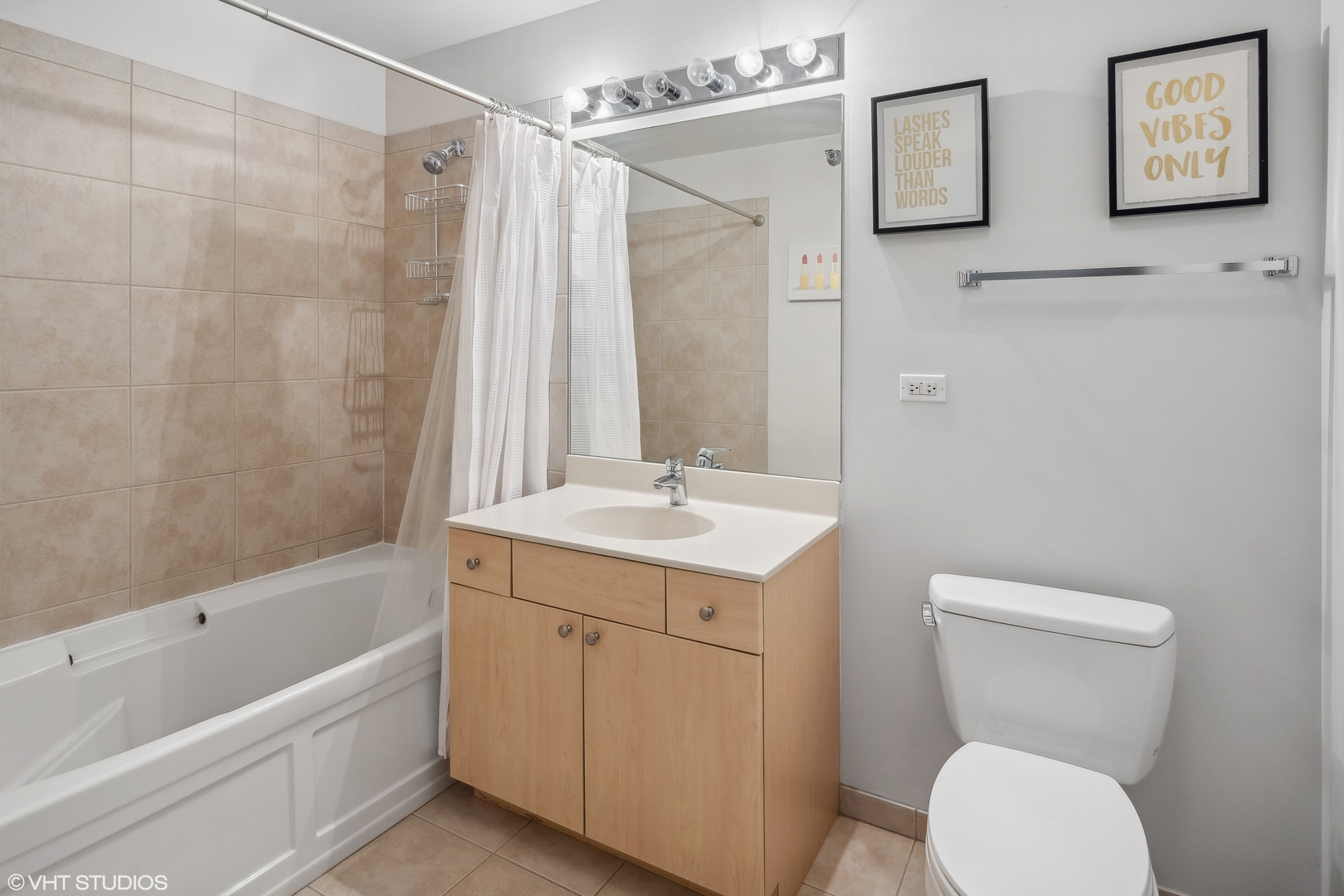 235 West Van Buren Street, Unit 2708 Chicago, IL 60607 - Photo 7 of 10 a bathroom with a granite countertop sink toilet and shower