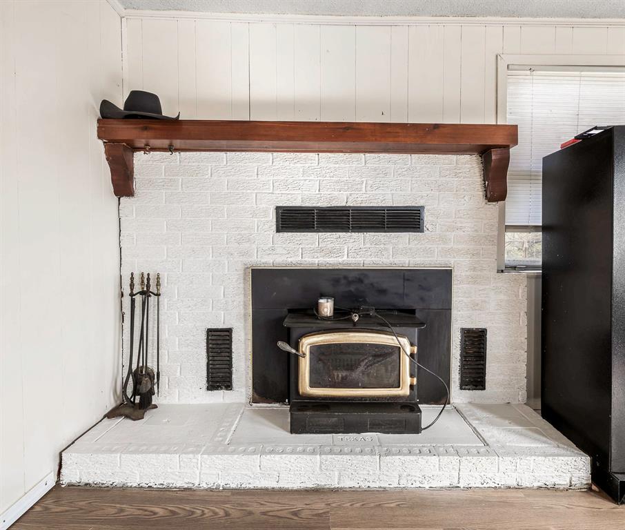 132 Maple Dublin, TX 76446 - Photo 11 of 27 a kitchen with a fireplace and a fireplace