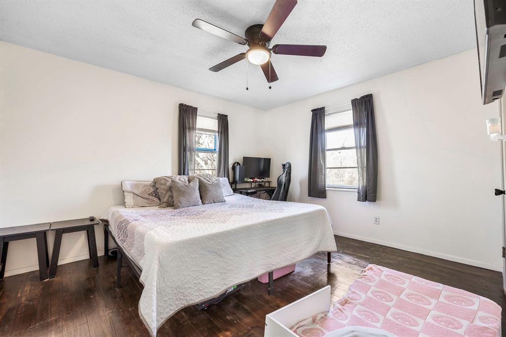132 Maple Dublin, TX 76446 - Photo 12 of 27 a bedroom with a bed and a dresser with wooden floor