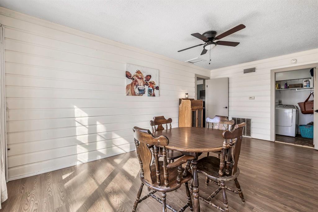 132 Maple Dublin, TX 76446 - Photo 3 of 27 a view of a dining room with furniture and wooden floor