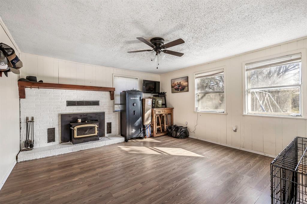 132 Maple Dublin, TX 76446 - Photo 10 of 27 a view of a livingroom with furniture hardwood floor and a ceiling fan