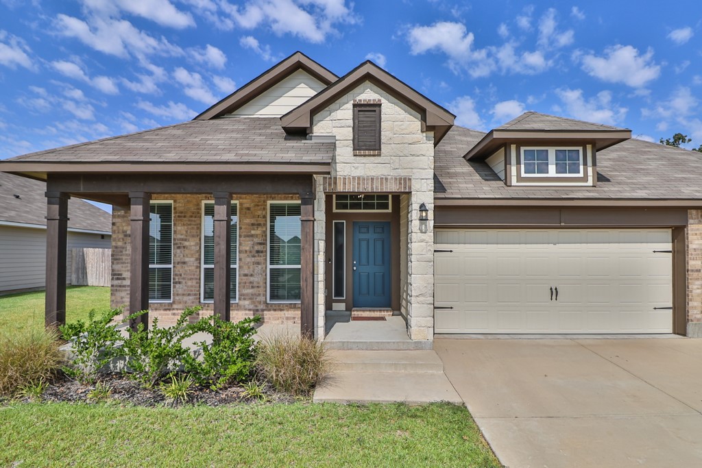 1926 Viva Road Bryan, TX 77807 - Photo 1 of 1 View of front of property featuring a shingled roof, driveway, a front yard, and brick siding
