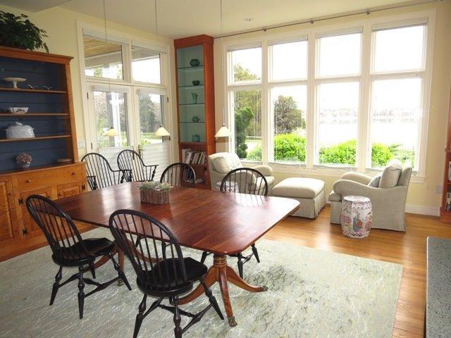 695 Fox Hill Road Chatham, MA 02633 - Photo 8 of 18 a dining room with furniture a chandelier and wooden floor
