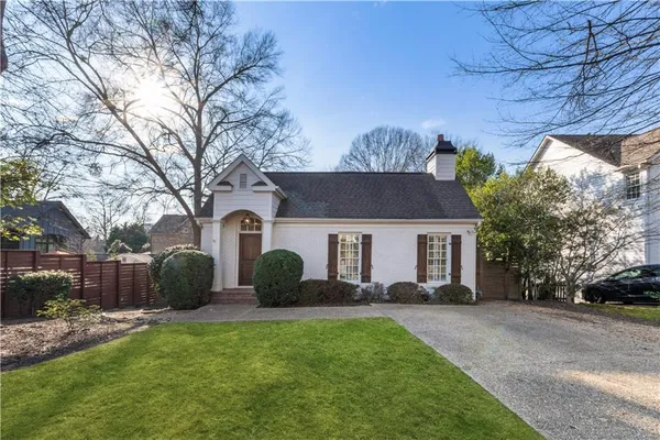 a front view of house with yard and trees