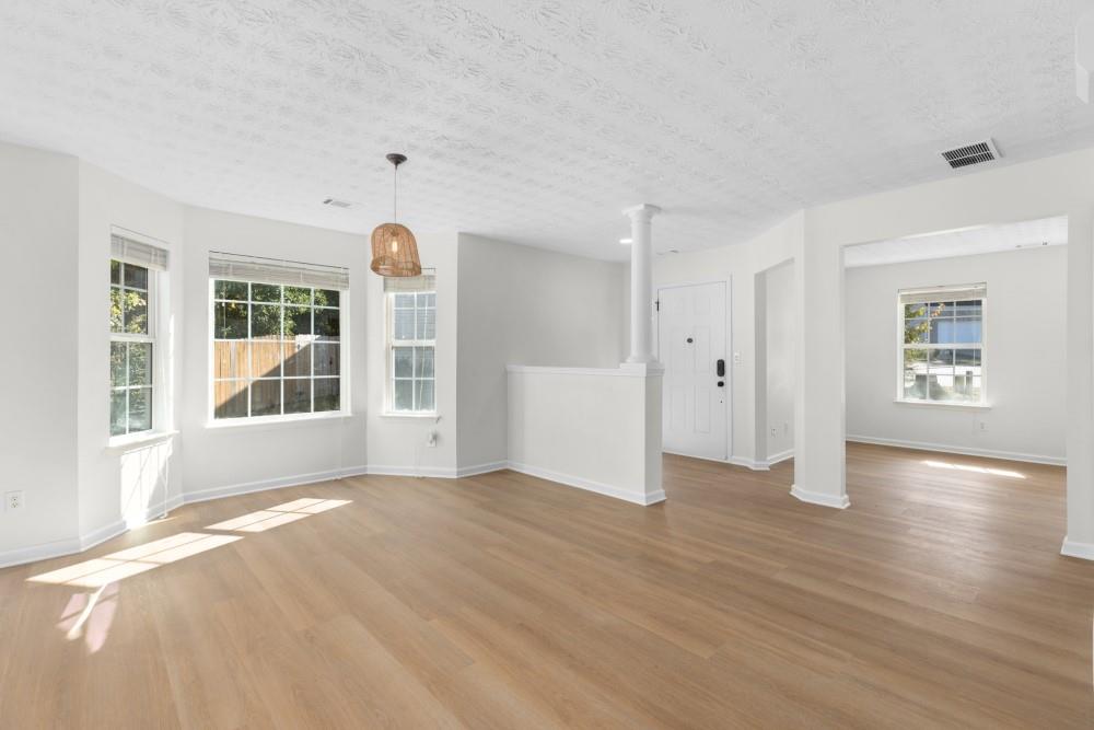 3501 Bogan Mill Road Northeast Buford, GA 30519 - Photo 13 of 59 a view of an empty room with window and wooden floor