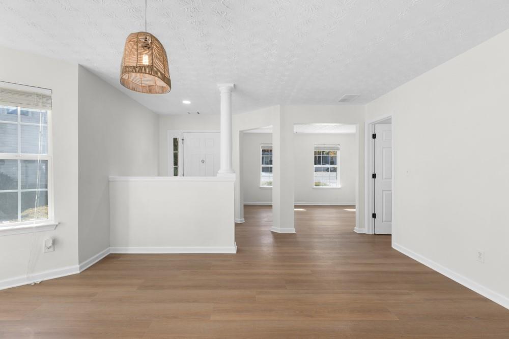 3501 Bogan Mill Road Northeast Buford, GA 30519 - Photo 14 of 59 an empty room with wooden floor and windows