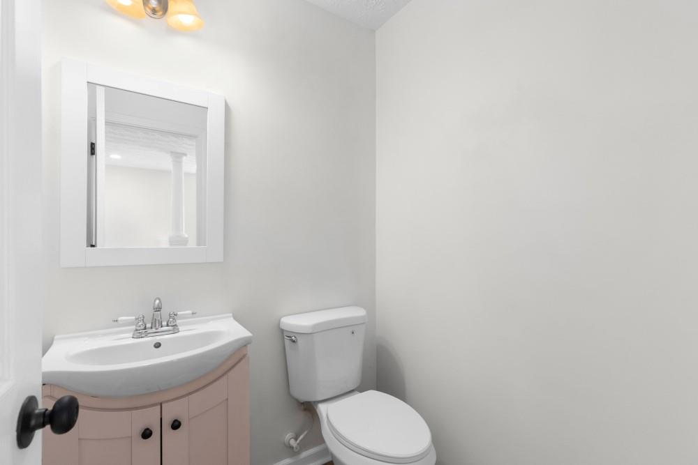 3501 Bogan Mill Road Northeast Buford, GA 30519 - Photo 16 of 59 a bathroom with a sink a toilet and mirror