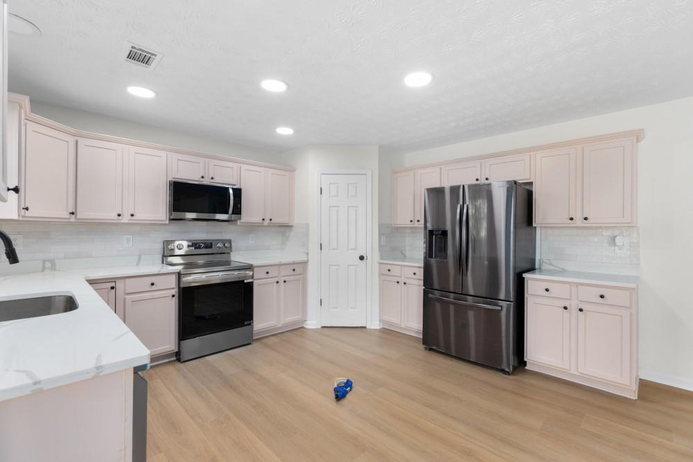 3501 Bogan Mill Road Northeast Buford, GA 30519 - Photo 20 of 59 a kitchen with granite countertop a refrigerator stove and sink
