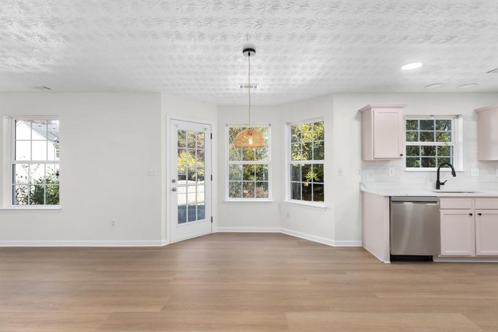 3501 Bogan Mill Road Northeast Buford, GA 30519 - Photo 27 of 59 a view of an empty room with a window and wooden floor