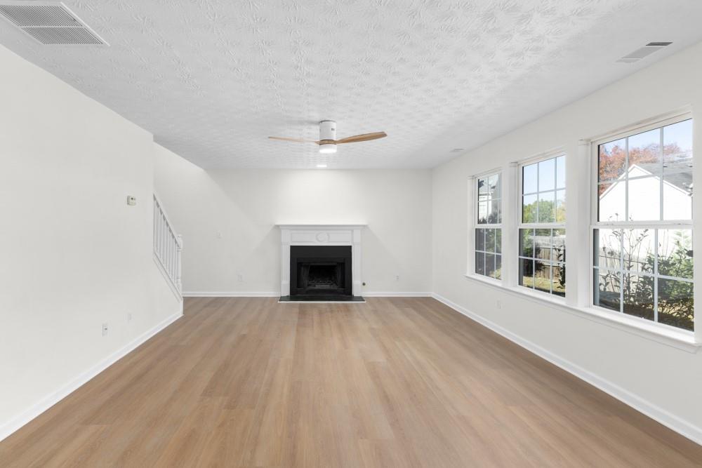 3501 Bogan Mill Road Northeast Buford, GA 30519 - Photo 28 of 59 an empty room with windows and fireplace