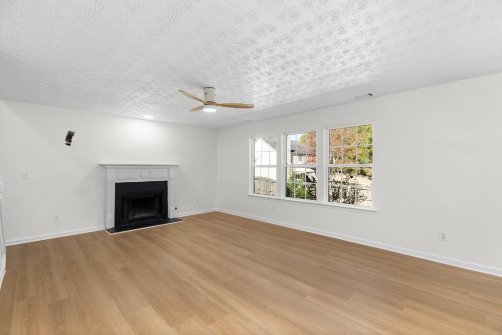 3501 Bogan Mill Road Northeast Buford, GA 30519 - Photo 30 of 59 a view of an empty room with a window and fireplace