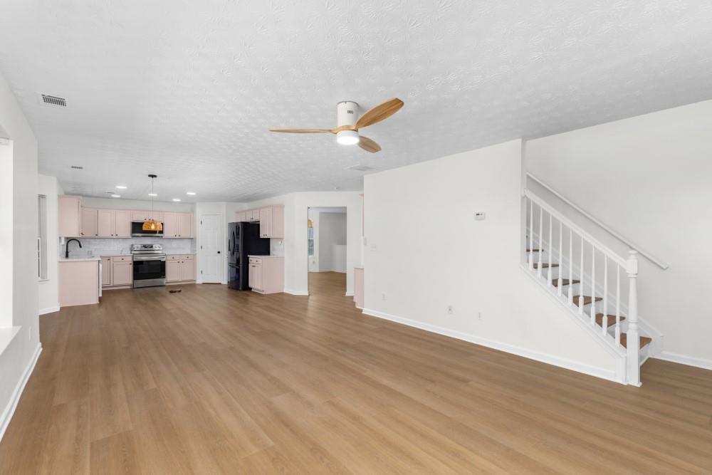 3501 Bogan Mill Road Northeast Buford, GA 30519 - Photo 31 of 59 a view of kitchen with furniture and wooden floor