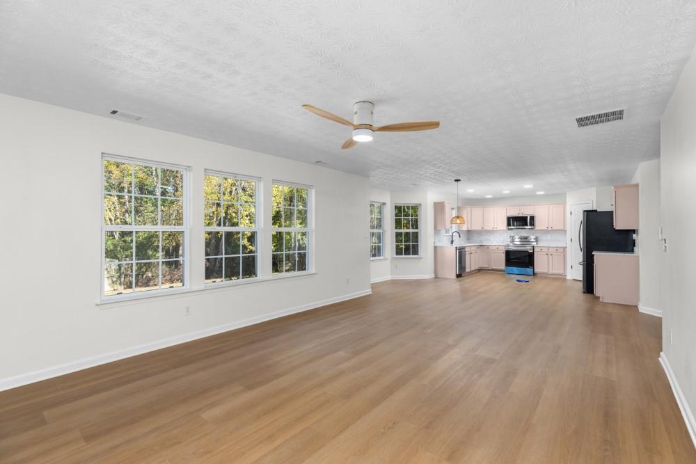 3501 Bogan Mill Road Northeast Buford, GA 30519 - Photo 32 of 59 a view of an empty room with a window and a kitchen