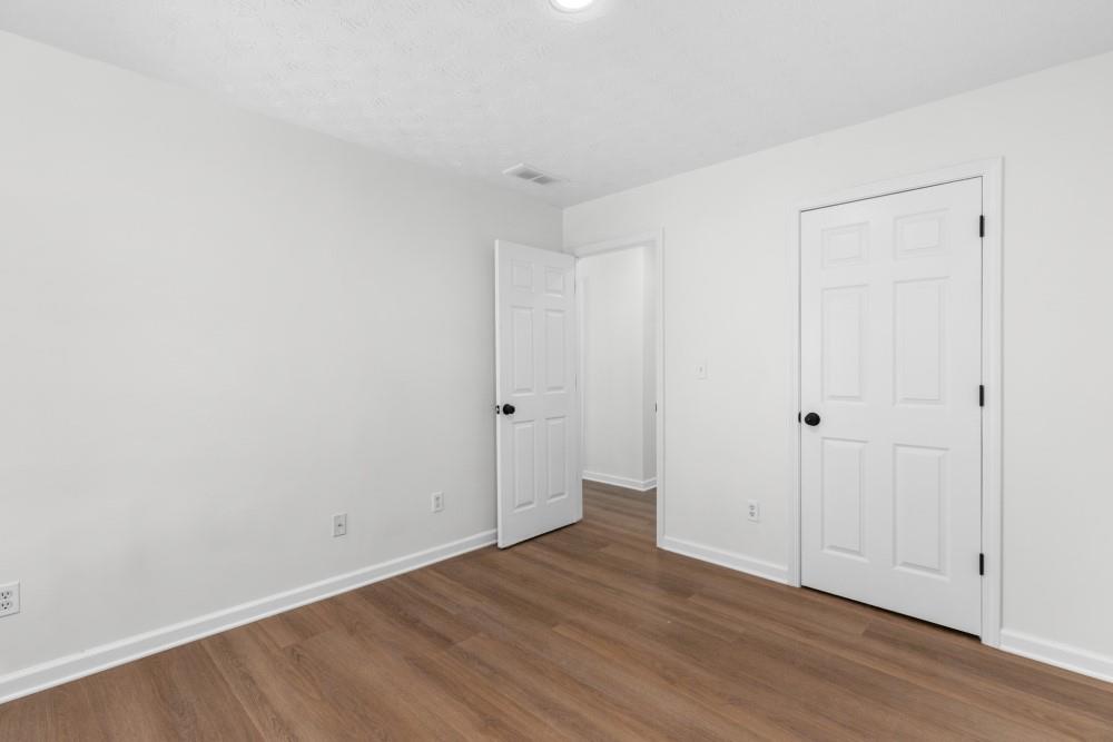 3501 Bogan Mill Road Northeast Buford, GA 30519 - Photo 37 of 59 a view of an empty room with wooden floor