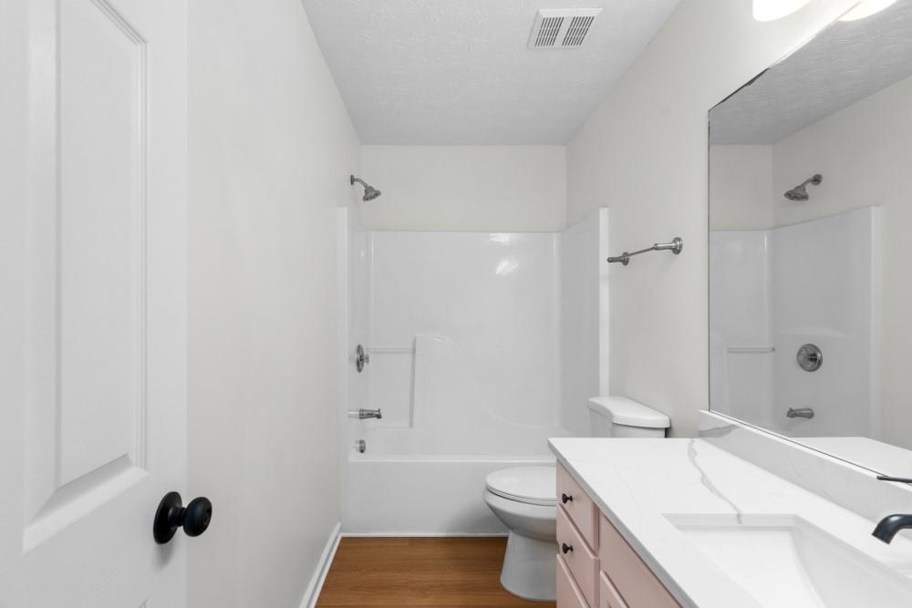 3501 Bogan Mill Road Northeast Buford, GA 30519 - Photo 40 of 59 a bathroom with a sink a toilet and shower