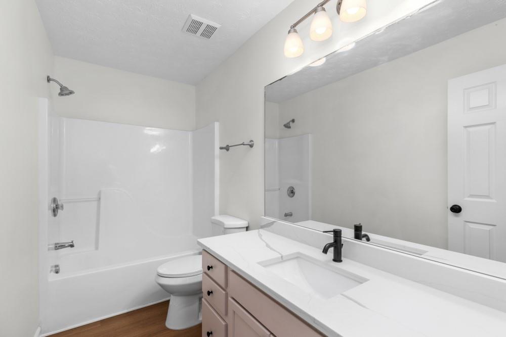 3501 Bogan Mill Road Northeast Buford, GA 30519 - Photo 41 of 59 a bathroom with a sink a toilet and shower