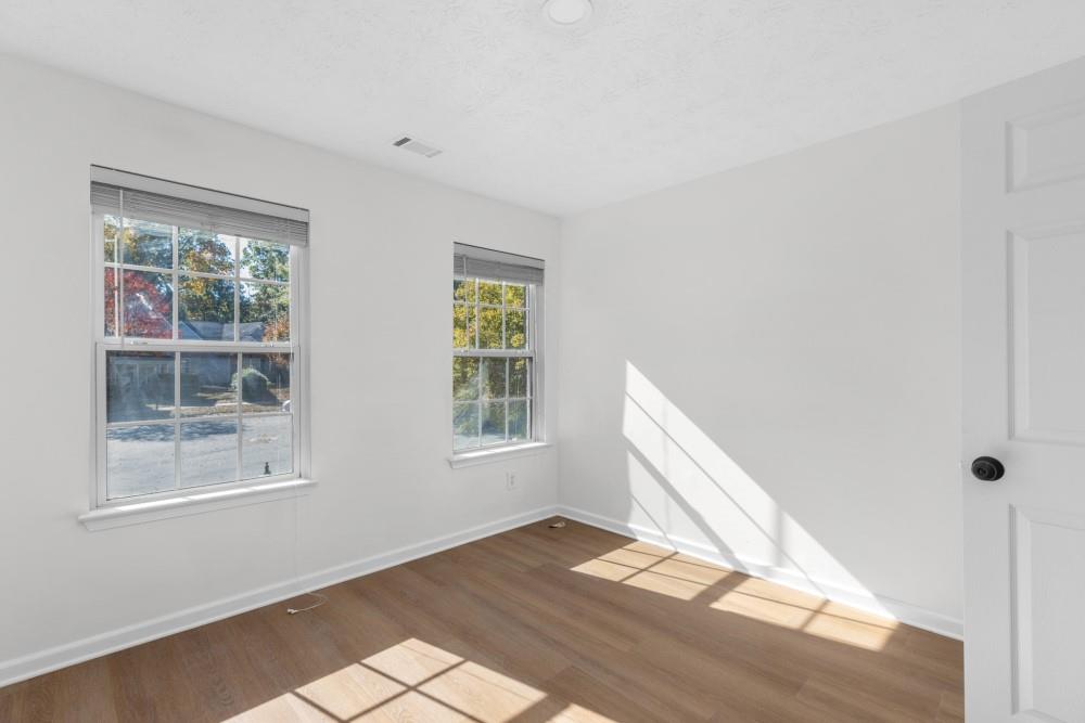 3501 Bogan Mill Road Northeast Buford, GA 30519 - Photo 44 of 59 a view of an empty room with wooden floor and a window