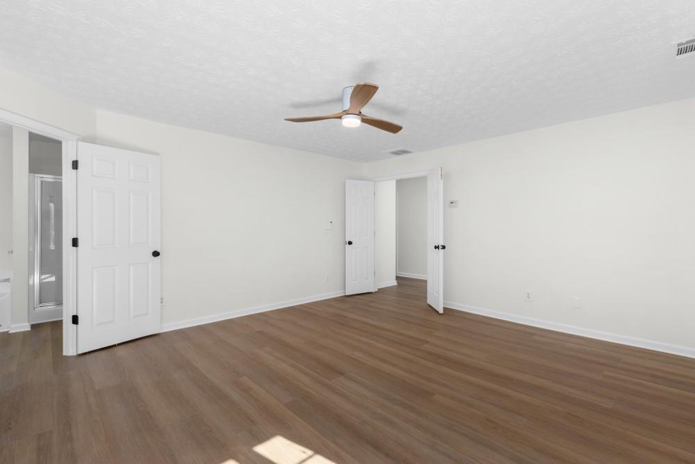 3501 Bogan Mill Road Northeast Buford, GA 30519 - Photo 48 of 59 a view of an empty room with wooden floor