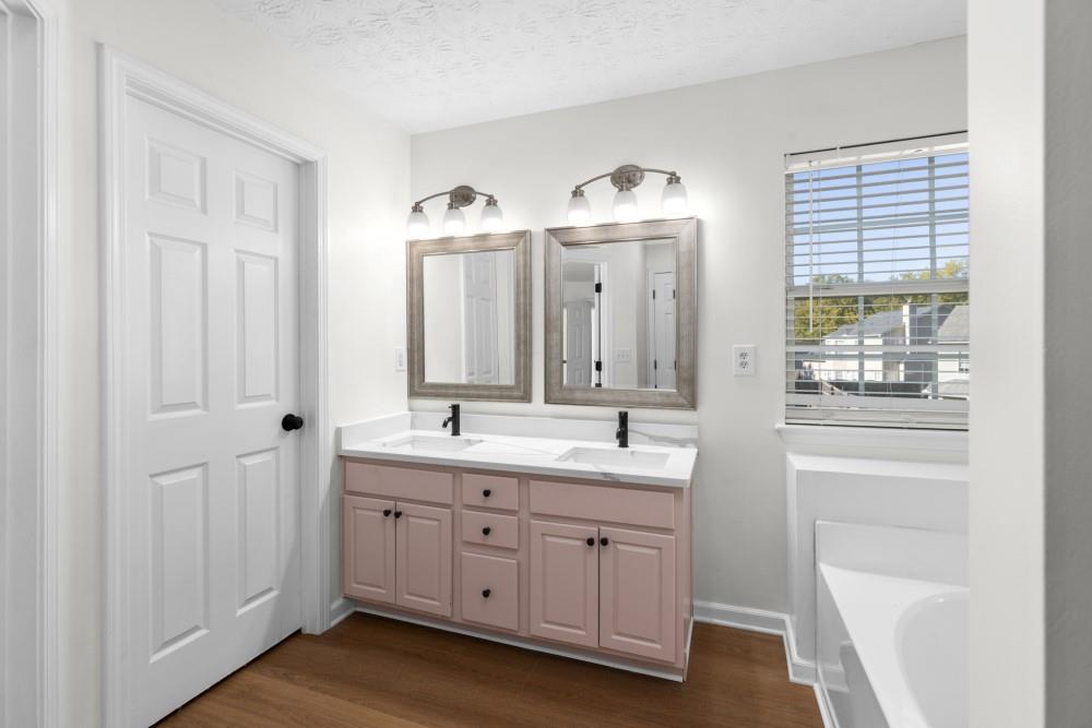 3501 Bogan Mill Road Northeast Buford, GA 30519 - Photo 50 of 59 a spacious bathroom with a double vanity sink a mirror and a shower