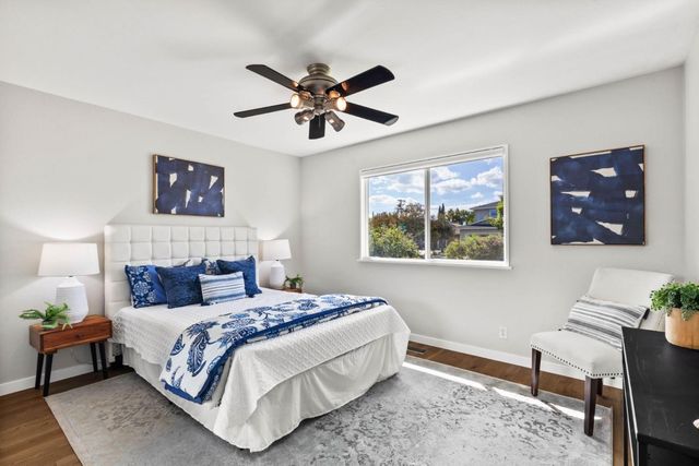 a bedroom with a bed and a painting on the wall