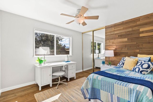 a bedroom with a bed a table and a window