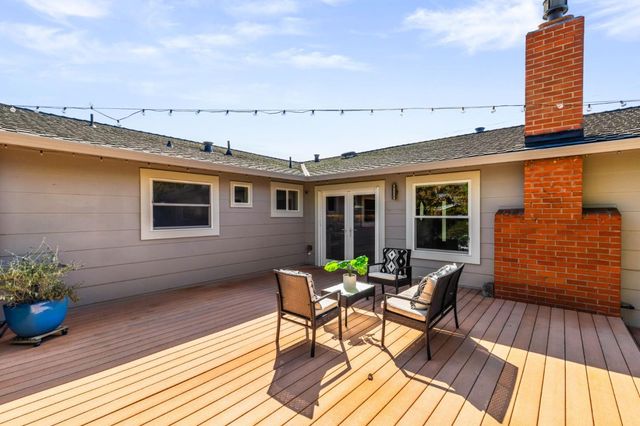 a balcony with wooden floor and breakfast area