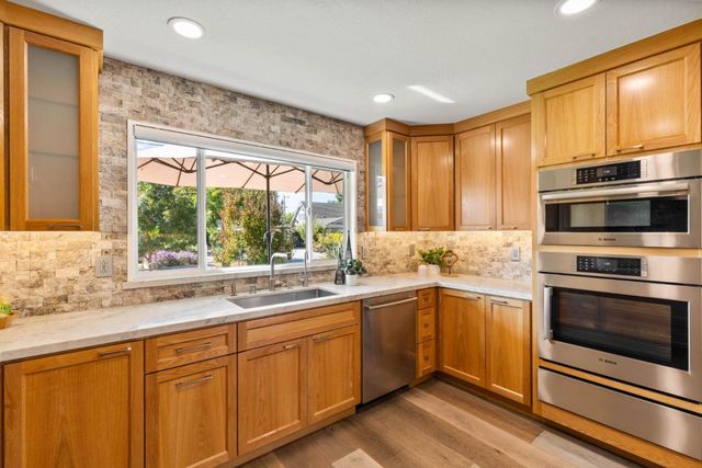 a kitchen with a sink stove and microwave