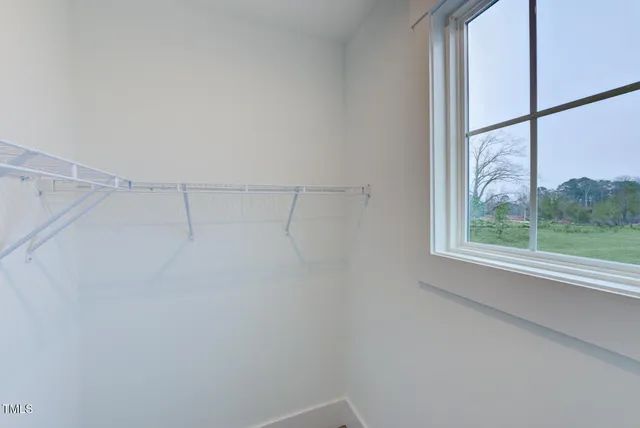 a bedroom with a bed and a lamp