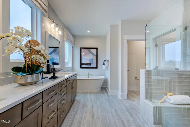 a kitchen with stainless steel appliances granite countertop a sink a stove top oven a counter space and living room view