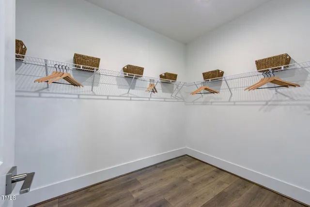 a kitchen with stainless steel appliances granite countertop a sink a stove and a wooden floors